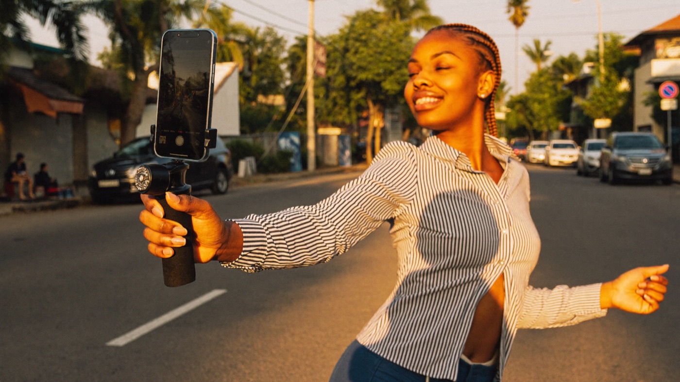 A creator filming a dance video on the street